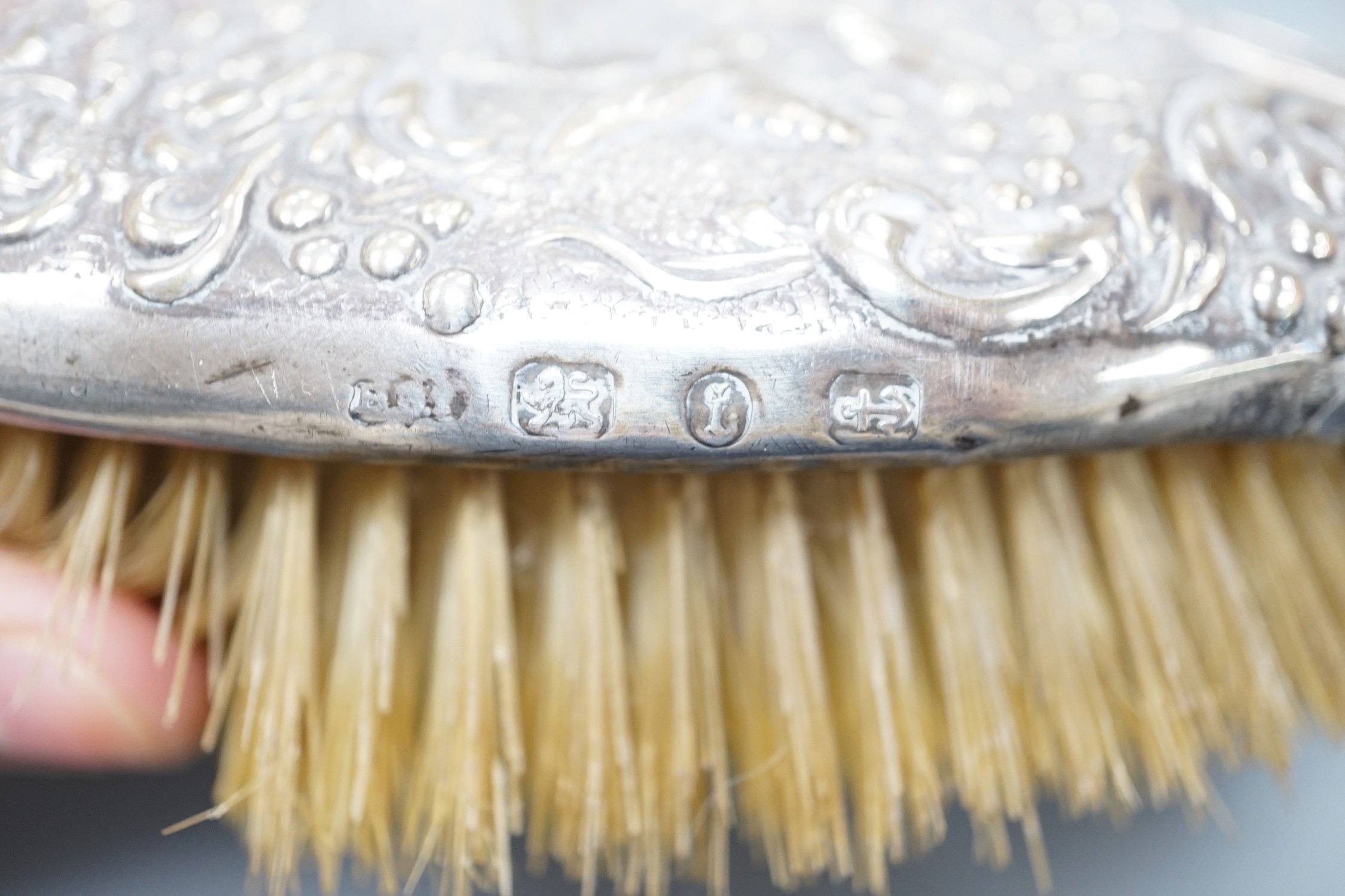 A pair of late Victorian repousse silver mounted hairbrushes, Birmingham, 1893.